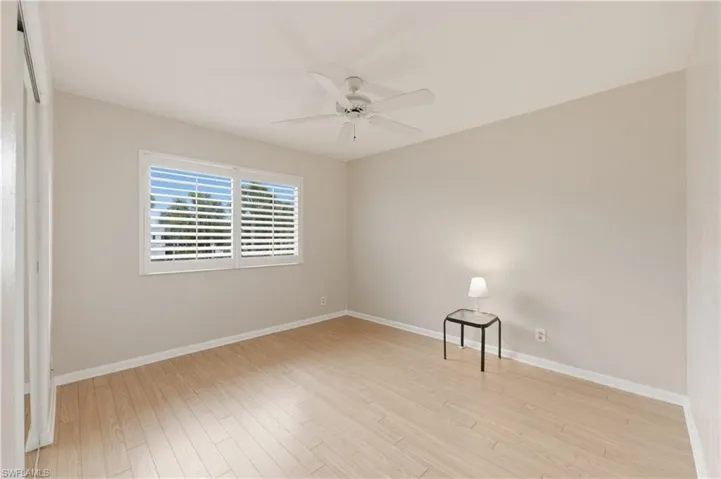 Spare Bedroom with light wood-style floors and a ceiling fan