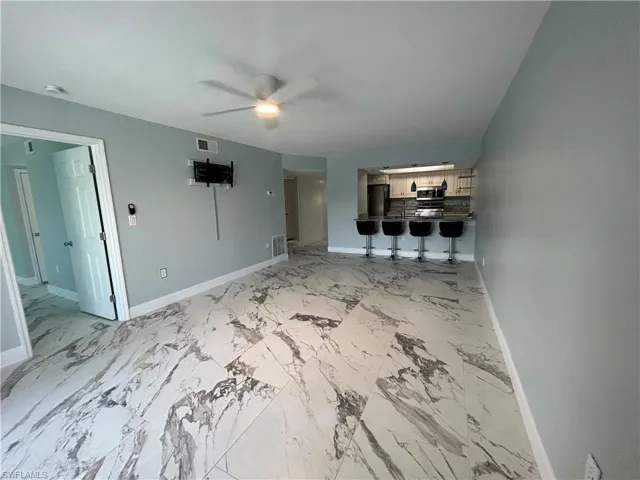 Living room and dining room looking toward kitchen
