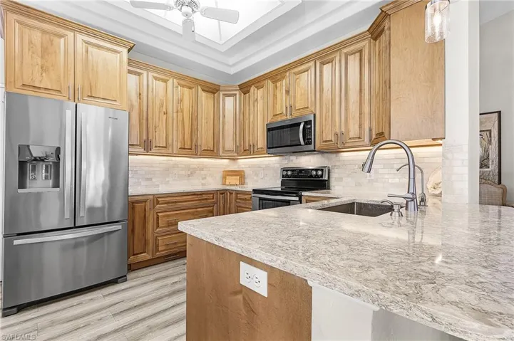 Incredible updated kitchen with stainless steel appliances, 42" wood cabinets, quartz counter tops, tile back splash.