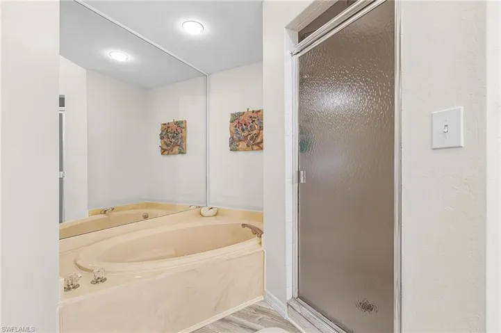 Guest bath features new vanity with dual sinks, new light fixtures, new mirrors, new LVT flooring, walk-in, tiled shower.