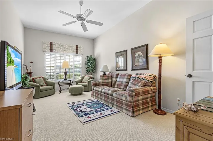 Light, bright and open primary bedroom en-suite with vaulted ceiling, ceiling fan, walk-in closet, berber carpet.