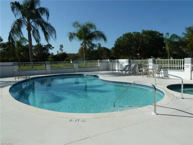 Spacious great room area with vaulted ceilings, ceiling fan, sliders out to the sun room.