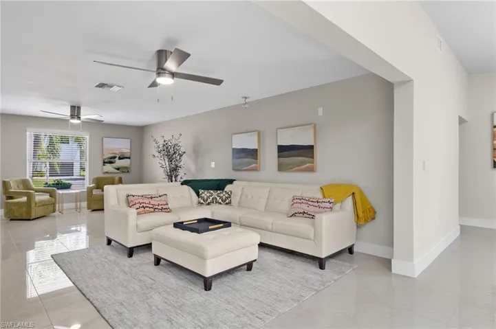 Tiled living room featuring ceiling fan