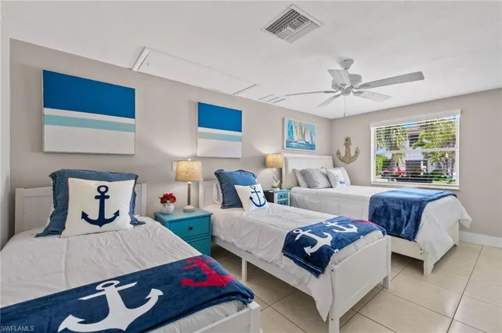 Tiled bedroom with ceiling fan
