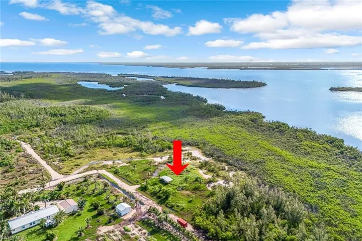 Aerial overview of property's location featuring a large body of water