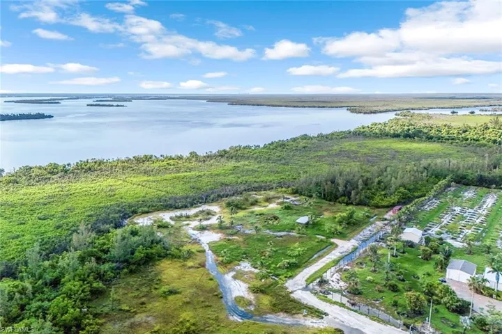 Aerial overview of property's location with a nearby body of water