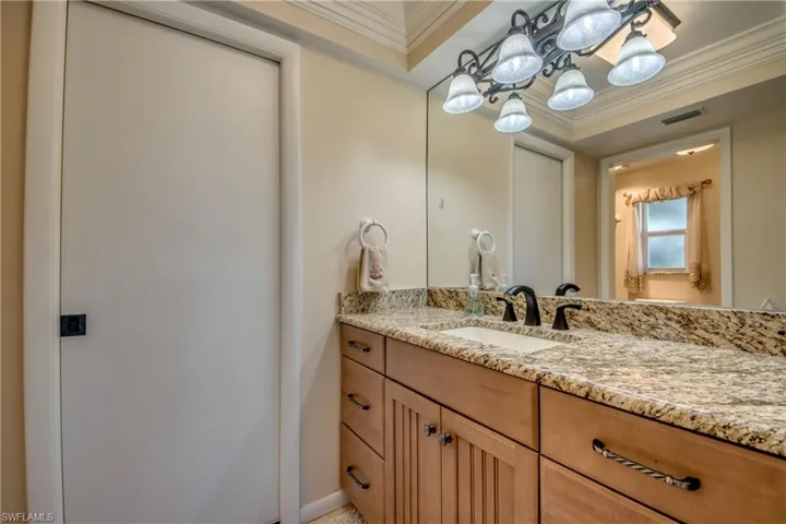 Bathroom with vanity and crown molding