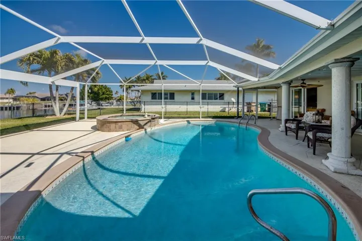 Combined pool / hot tub with a patio area, a sunroom, and a lanai
