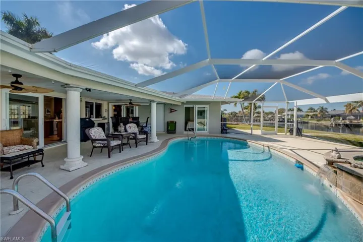 Swimming pool with a sunroom, a patio area, a lanai, and an outdoor lounge area