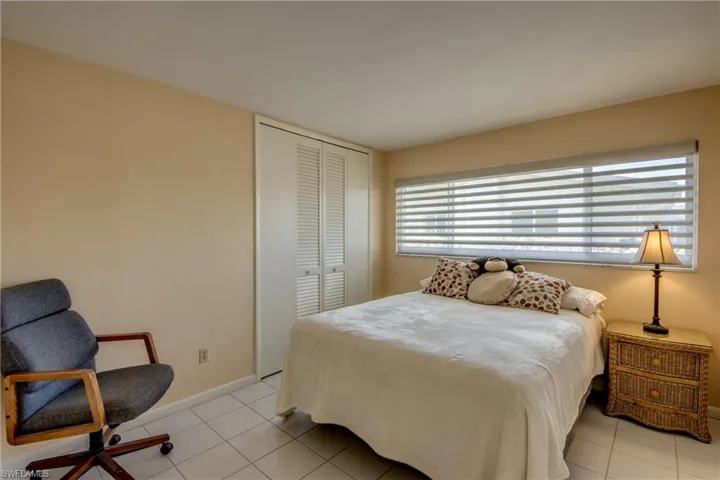 Bedroom featuring light tile patterned flooring and a closet