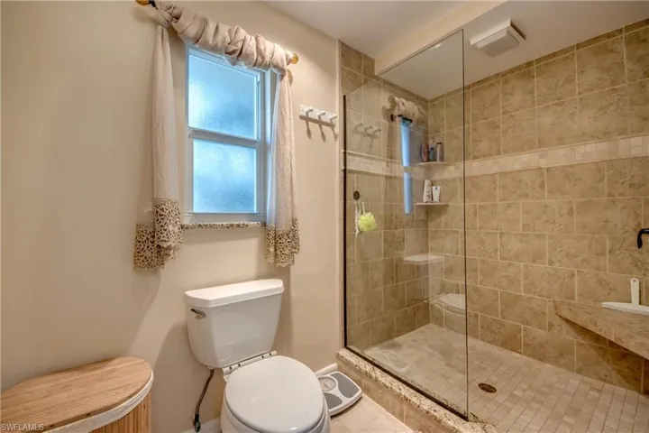 Full bathroom featuring a tile shower