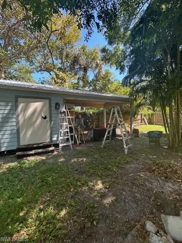 Carport with metal roog and attached shed