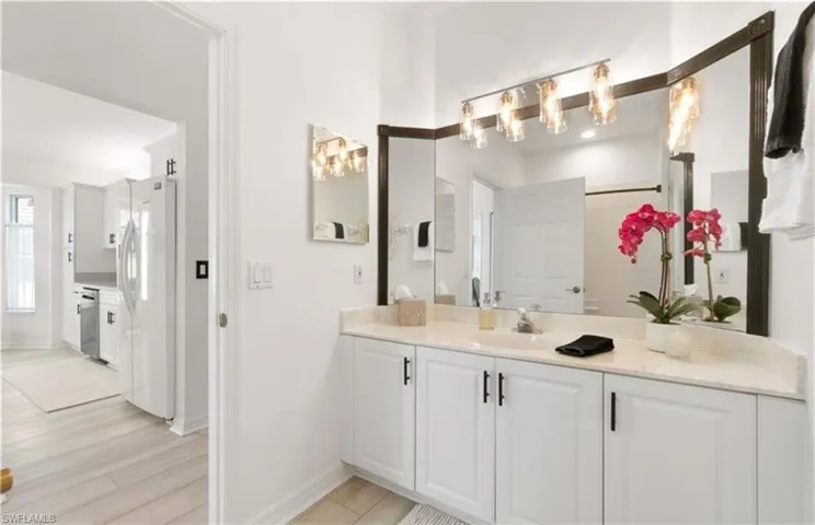 Bathroom with baseboards, wood finished floors, and vanity