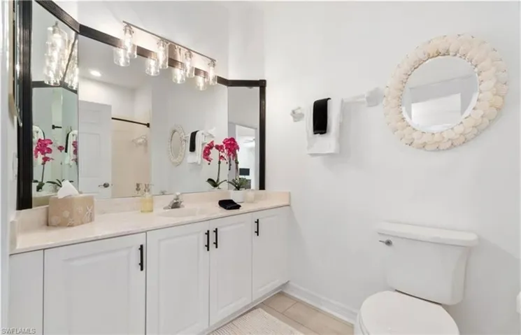 Full bathroom with vanity, toilet, baseboards, tile patterned floors, and walk in shower