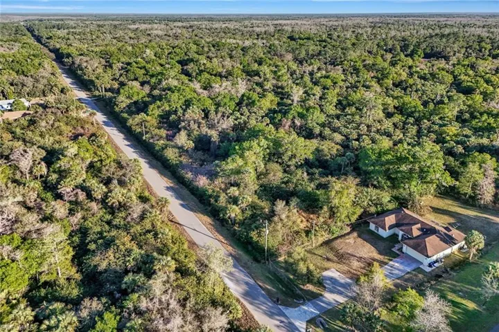 View of property location featuring a heavily wooded area
