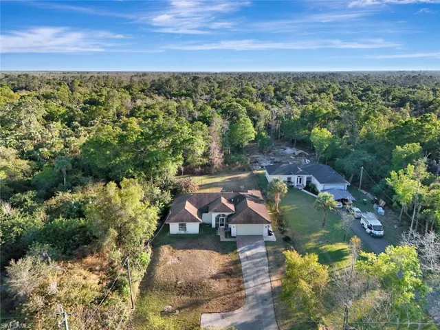 View of subject property with a forest