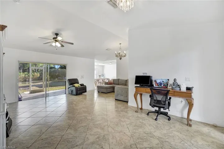 Office with hanging lights and a ceiling fan