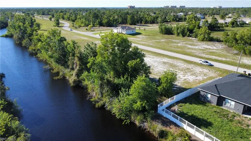 Birds eye view of property with a water view