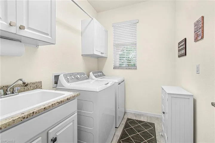 Laundry room featuring cabinet space and separate washer and dryer