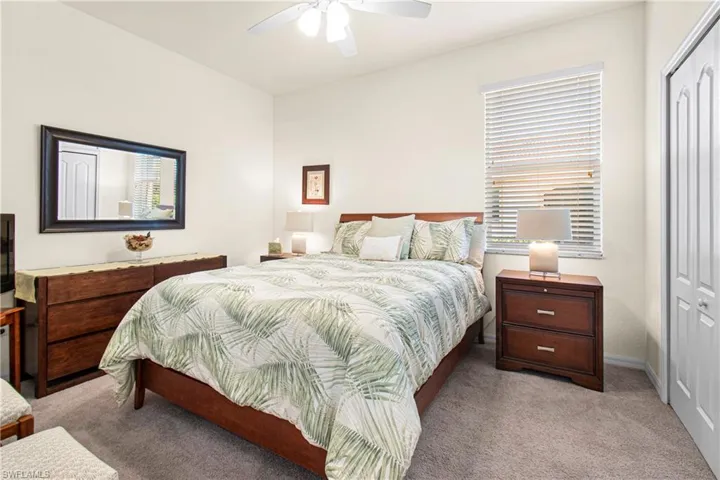Guest Bedroom  ornamental molding, ceiling fan, and ensuite bathroom