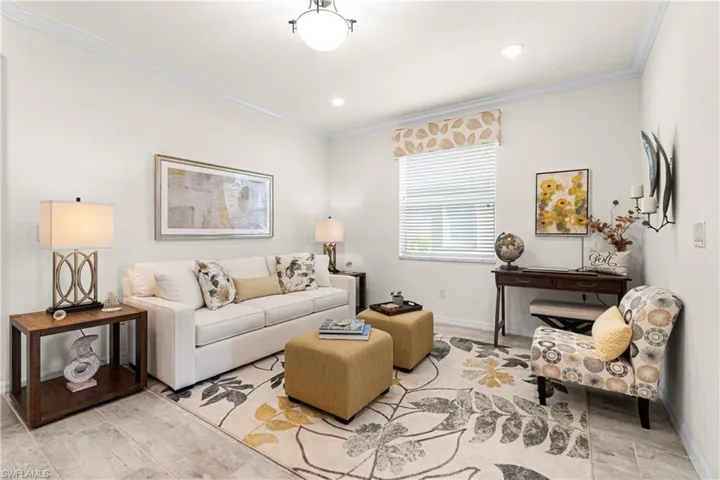 Living area or extra office / Den featuring ornamental molding and wood tiled floors