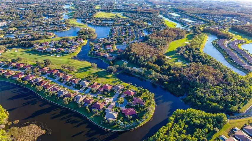 Aerial view of property's location with a large body of water