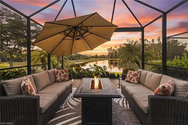 View of patio / terrace with a lanai, a sunroom, a water view, and an outdoor hangout area