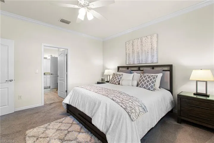 Main Bedroom  ornamental molding, ceiling fan, and ensuite bathroom