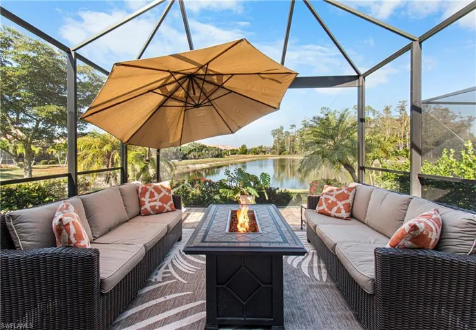 View of patio with a lanai, a sunroom, a water view, and an outdoor living space