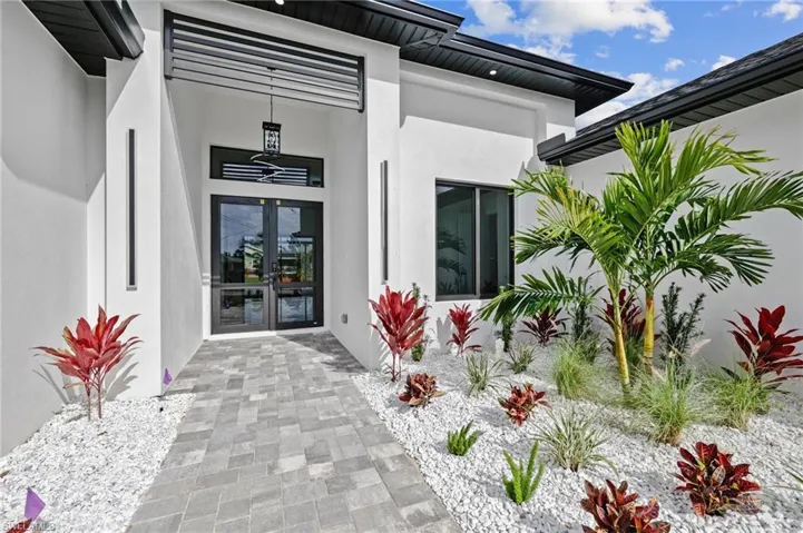 Entrance to property featuring french doors and stucco siding