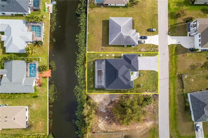 Birds eye view of property featuring a water view and a residential view