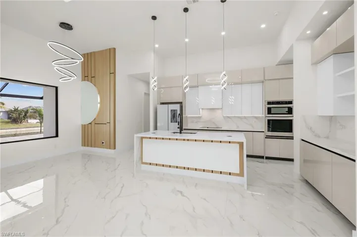 Kitchen featuring marble finish floor and modern cabinets
