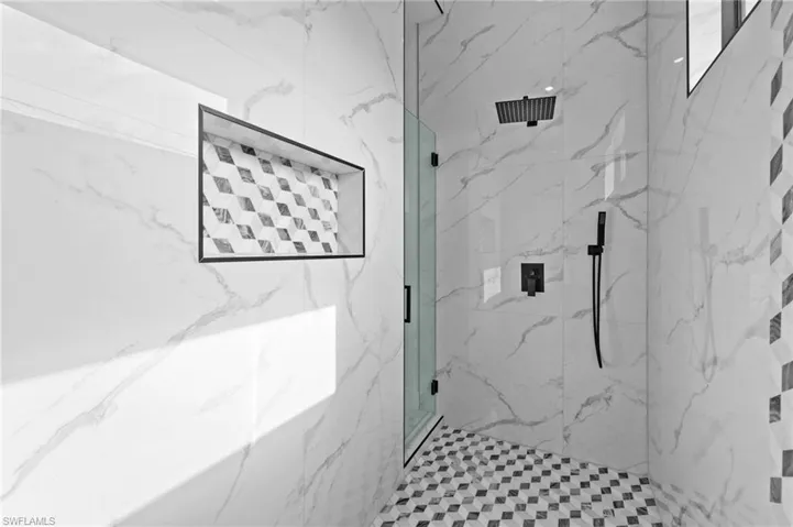 Bathroom with a marble finish shower