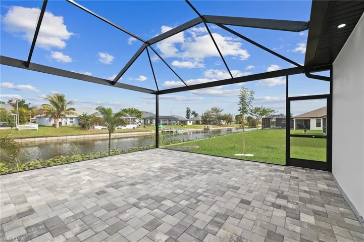 Unfurnished sunroom with a water view and a residential view