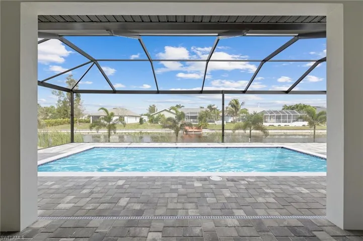 Outdoor pool with a lanai and a patio area
