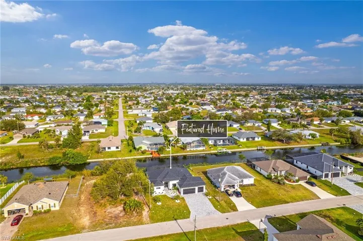 Aerial view featuring a water view and a residential view
