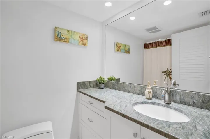 Guest Bathroom with Granite counters and tub/shower combo