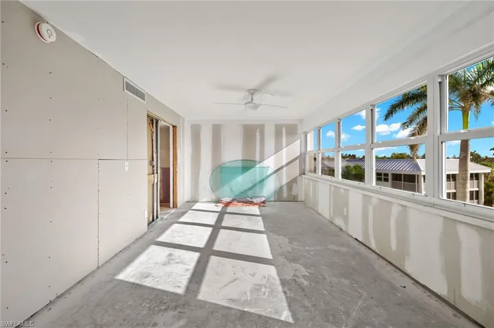 Unfurnished sunroom featuring ceiling fan