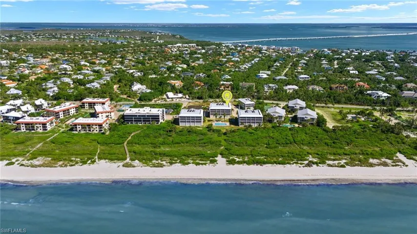 Drone / aerial view with a view of the beach and a water view