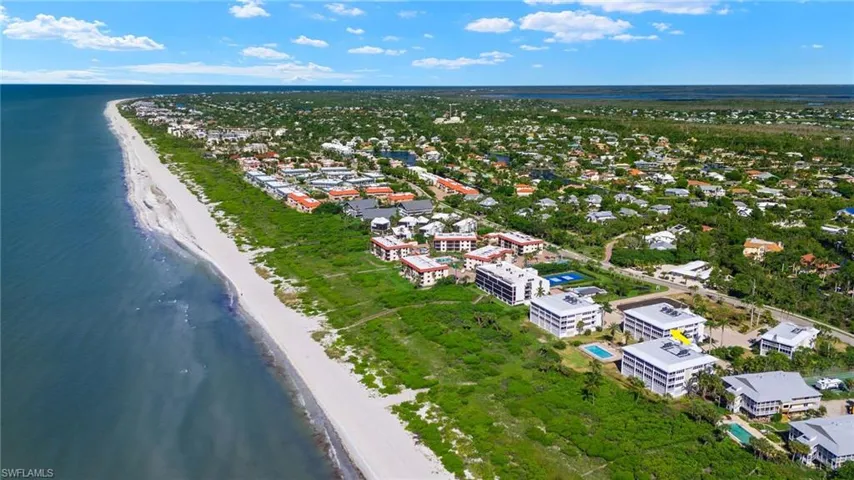 Aerial view with a water view and a beach view