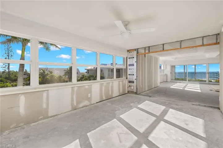 Unfurnished sunroom featuring ceiling fan