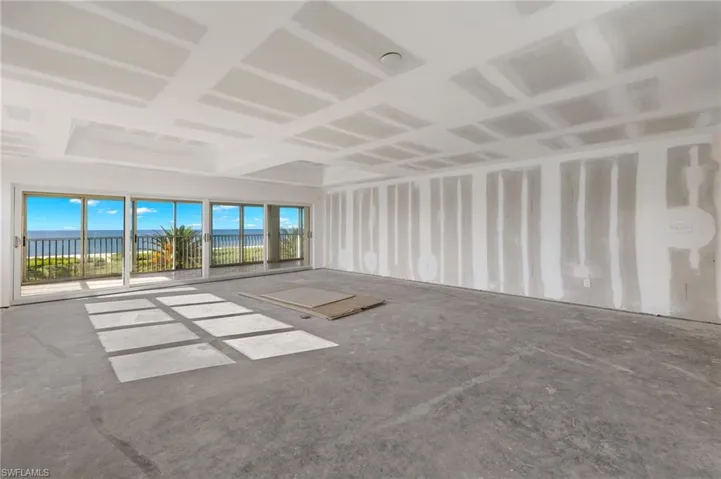 Unfurnished living room with concrete floors and a water view