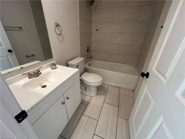 Full bathroom featuring vanity, shower / tub combination, and tile patterned floors