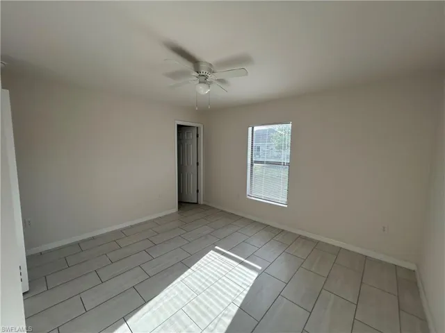 Spare room featuring baseboards and a ceiling fan