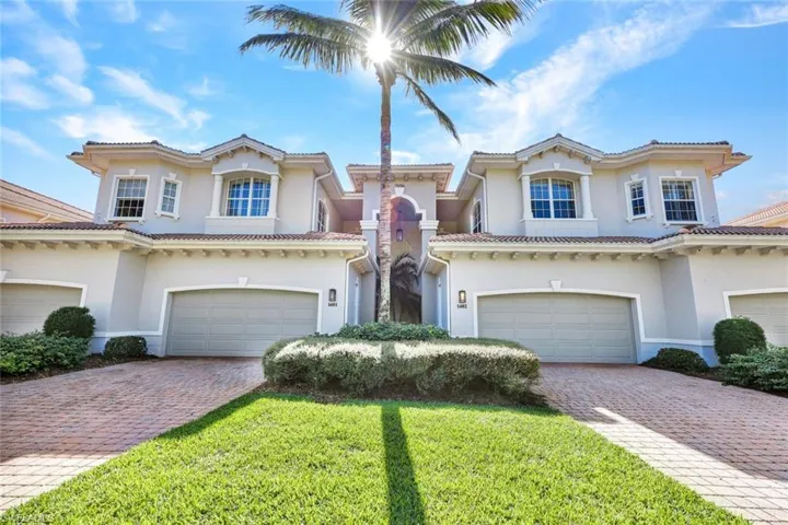 Mediterranean / spanish house featuring a front yard and a garage