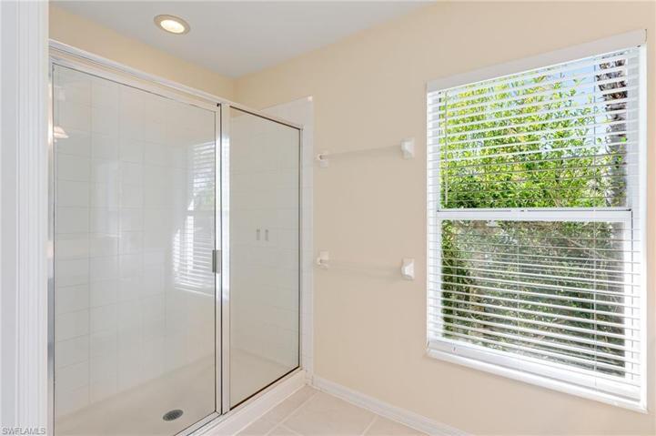 Oversized, glass-enclosed shower.
