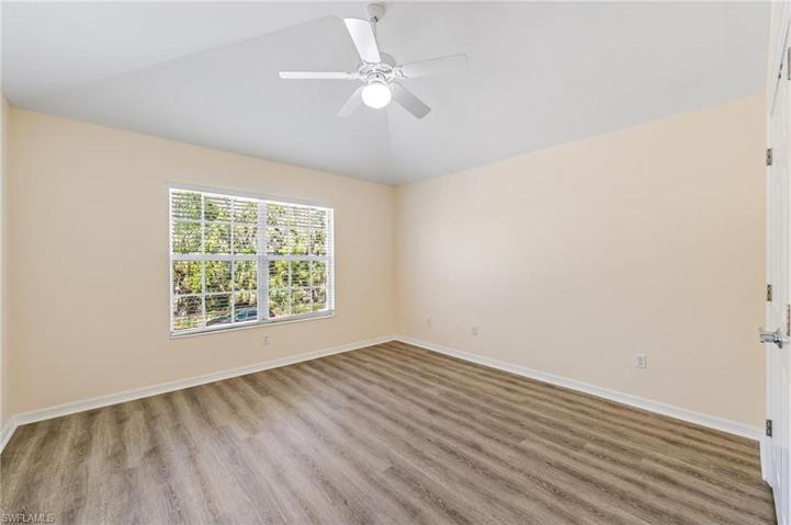 Bedroom #3 with vaulted ceilings and large window.
