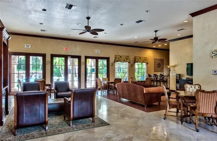 Community lobby featuring ornamental molding and a textured ceiling