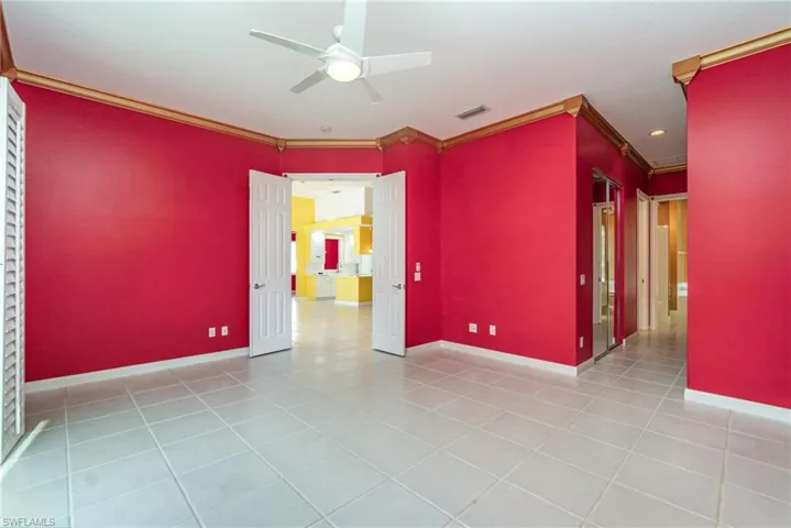 Unfurnished room with light tile patterned floors, ceiling fan, and ornamental molding