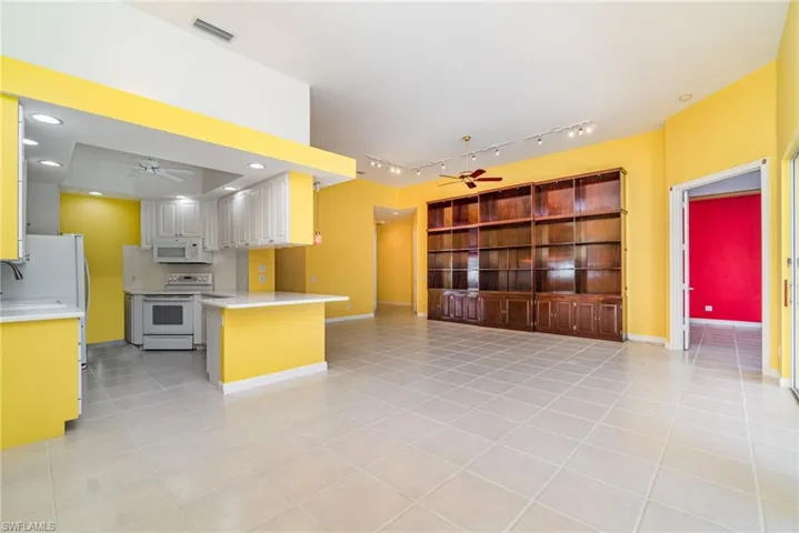 Kitchen featuring ceiling fan, white appliances, light tile patterned floors, light countertops, and recessed lighting